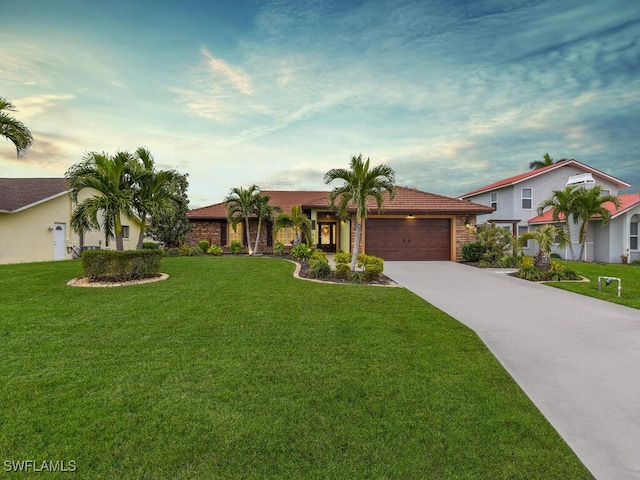 view of front of house with a garage and a yard