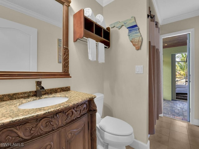 bathroom with crown molding, toilet, tile patterned floors, and vanity