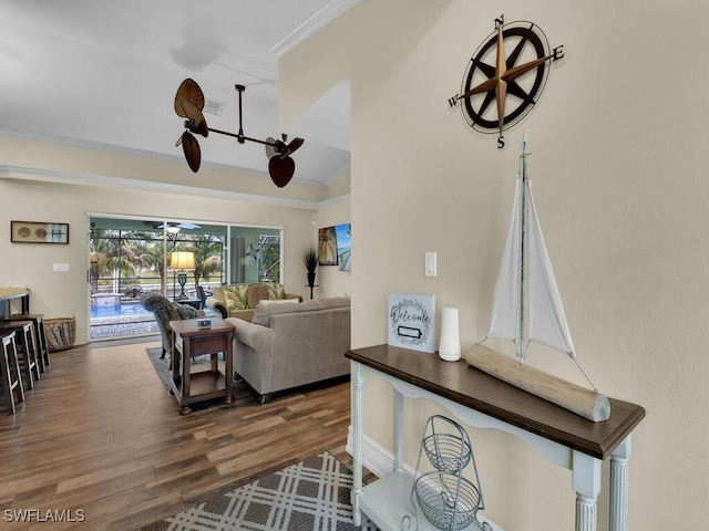 living room featuring crown molding, dark wood-type flooring, and lofted ceiling