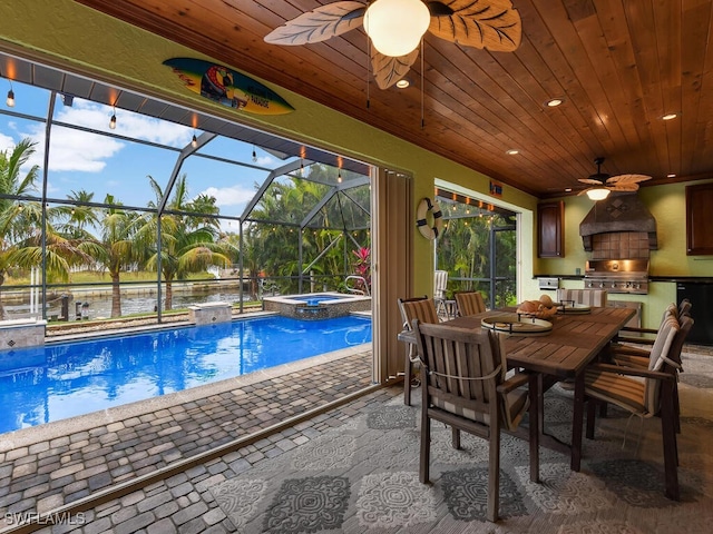 view of swimming pool featuring exterior kitchen, a patio area, an in ground hot tub, a water view, and area for grilling