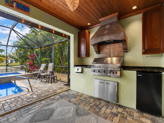 view of patio / terrace with exterior kitchen and a grill