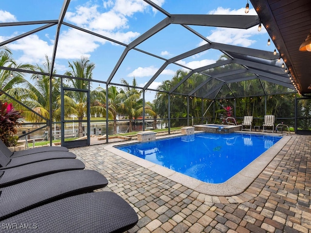 view of pool featuring glass enclosure, an in ground hot tub, a water view, and a patio