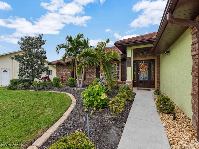 property entrance with a yard