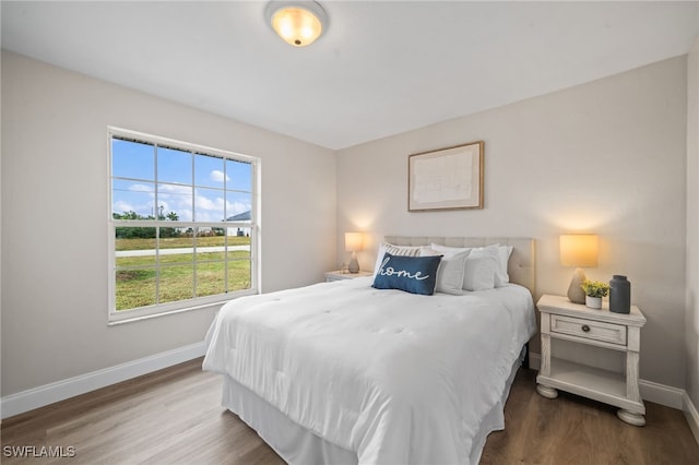 bedroom featuring multiple windows and hardwood / wood-style floors