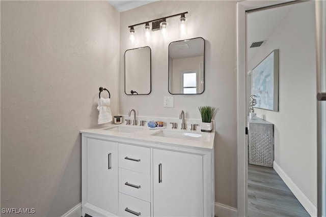 bathroom featuring vanity and hardwood / wood-style floors