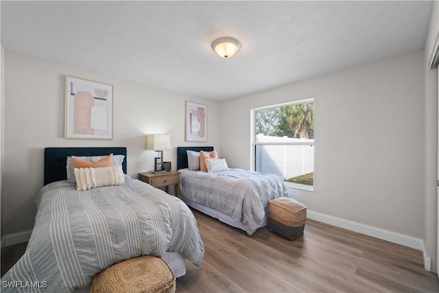 bedroom with wood-type flooring