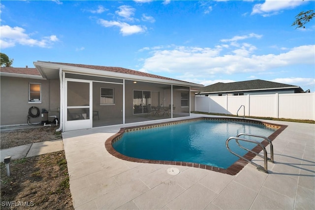 view of swimming pool with a patio area and a sunroom