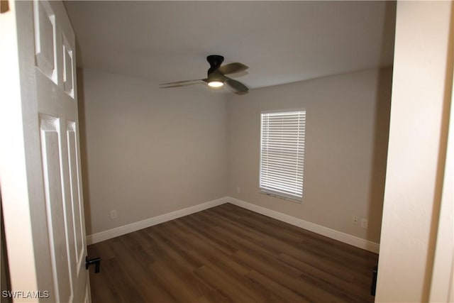 unfurnished room with ceiling fan and dark wood-type flooring