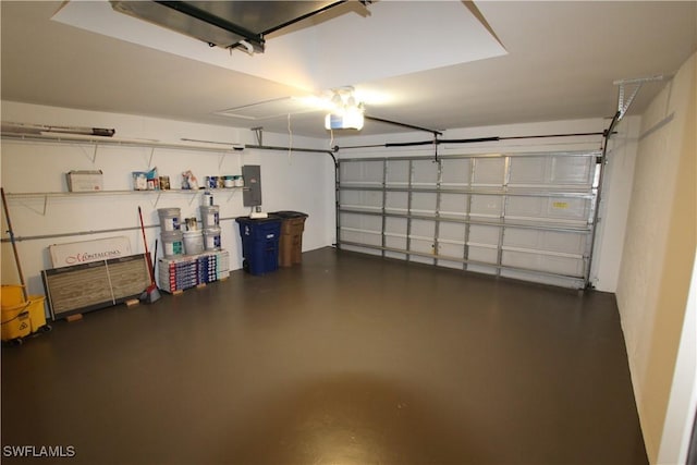 garage with electric panel and a garage door opener