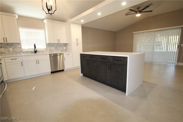 kitchen with vaulted ceiling, white cabinetry, dishwasher, and decorative light fixtures