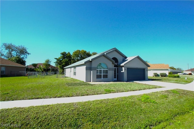 ranch-style house featuring a garage and a front lawn