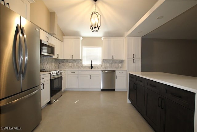 kitchen featuring decorative light fixtures, white cabinetry, appliances with stainless steel finishes, and a chandelier