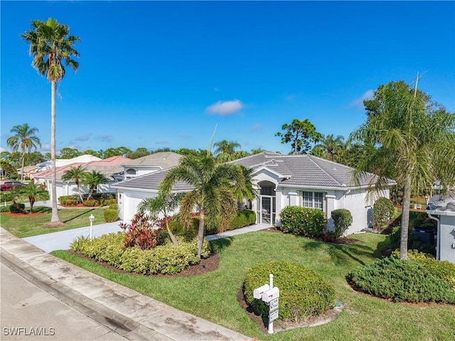 view of front of property with a front yard and a garage