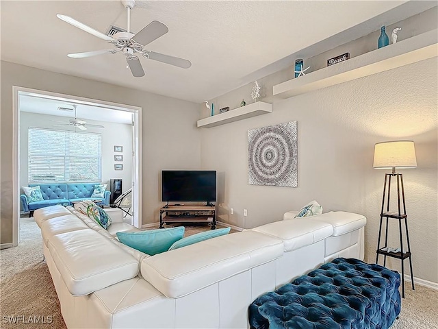 living room with carpet flooring and ceiling fan