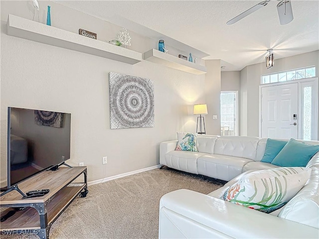 living room with ceiling fan and carpet floors