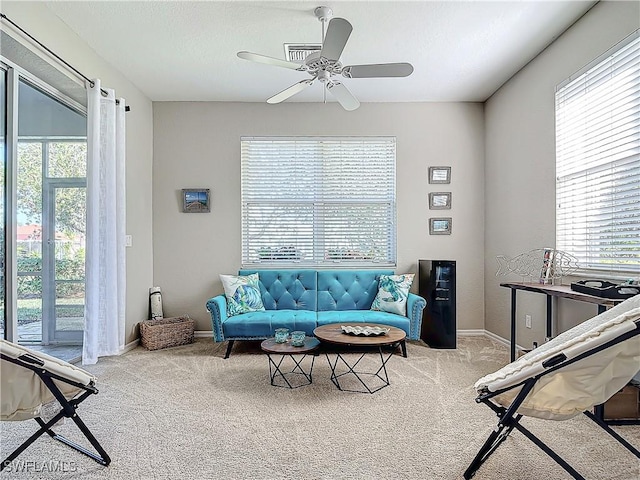 carpeted living room featuring ceiling fan