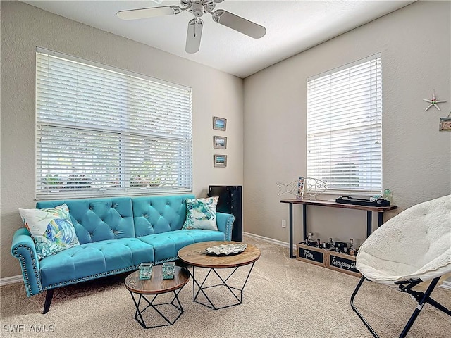 carpeted living room with ceiling fan and a healthy amount of sunlight