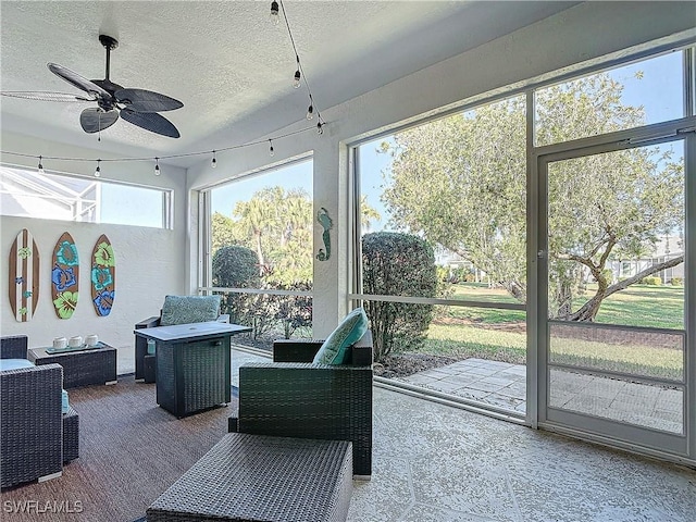 sunroom featuring ceiling fan