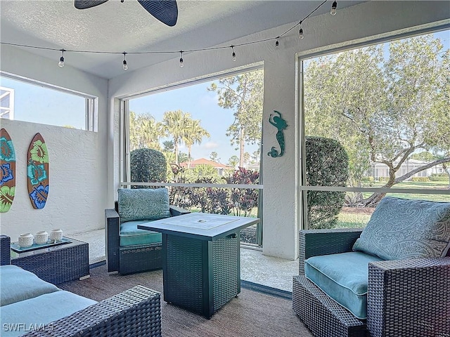 sunroom / solarium featuring a wealth of natural light and ceiling fan