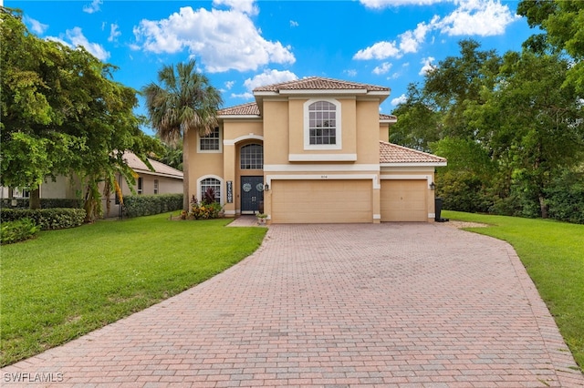 mediterranean / spanish-style home with a front yard and a garage