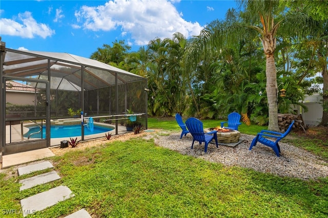 view of yard featuring a lanai and an outdoor fire pit