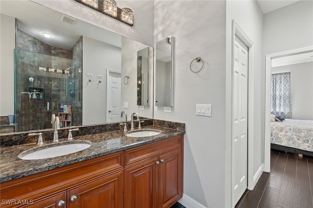 bathroom with a shower with door, vanity, and hardwood / wood-style flooring