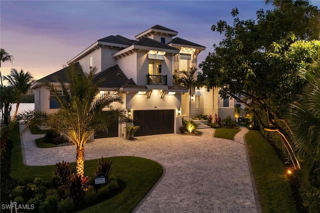 view of front of home featuring a balcony and a garage