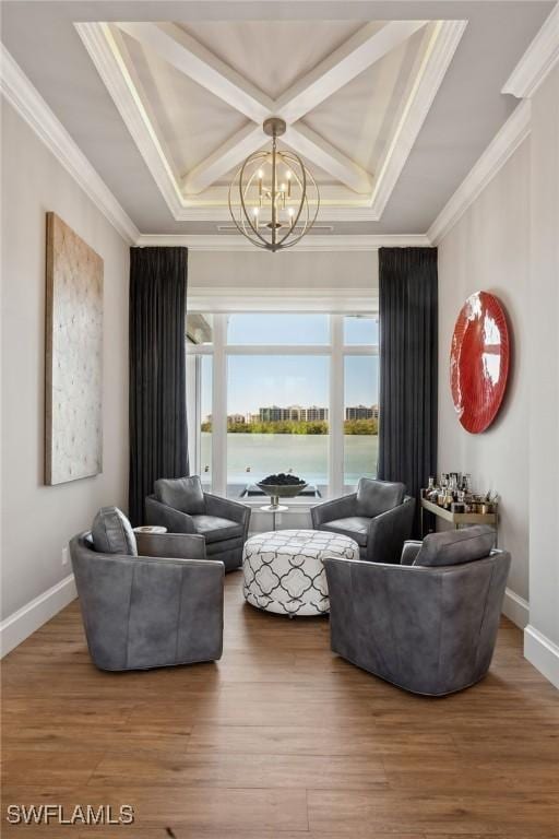 living room with hardwood / wood-style flooring, ornamental molding, a chandelier, and a water view