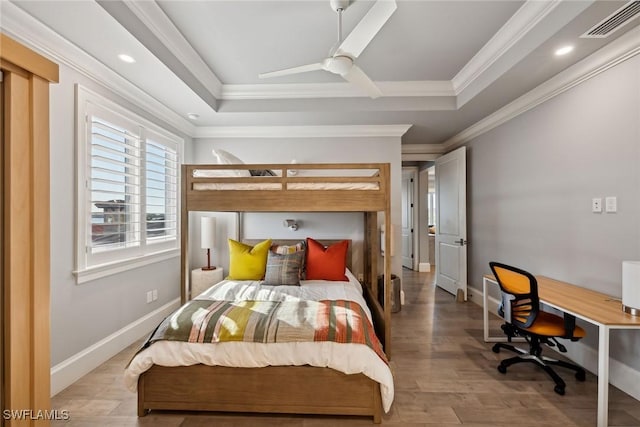 bedroom with ceiling fan, ornamental molding, and a raised ceiling