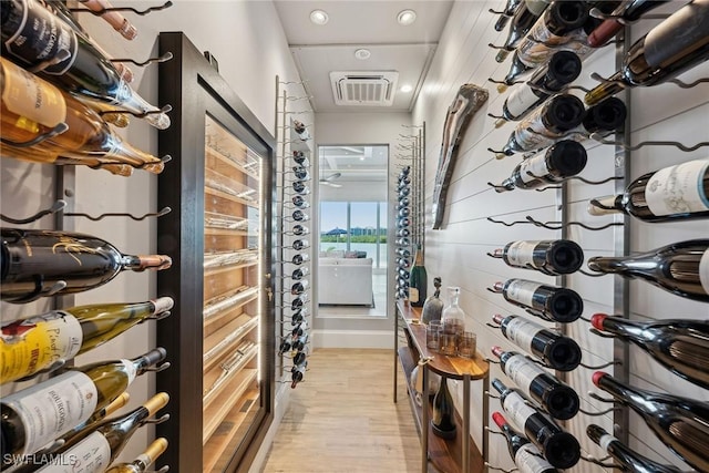 wine cellar with light hardwood / wood-style flooring