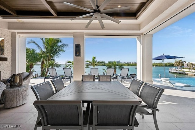 view of patio / terrace with ceiling fan and a water view