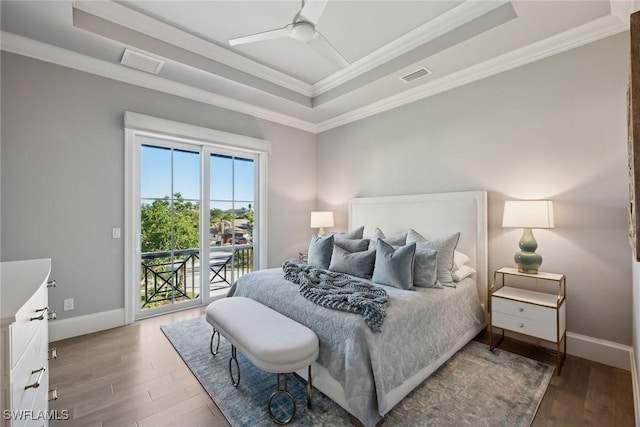 bedroom featuring a raised ceiling, access to exterior, ceiling fan, and ornamental molding