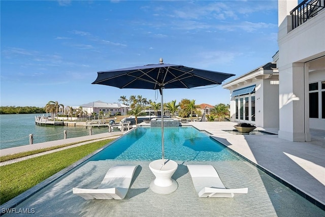 view of pool with a patio, french doors, and a water view