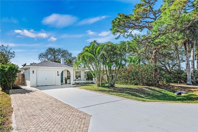 view of front of home featuring a garage and a front lawn