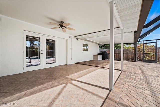 view of patio with french doors, ceiling fan, and glass enclosure