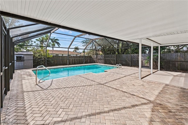 view of swimming pool with a patio area and glass enclosure