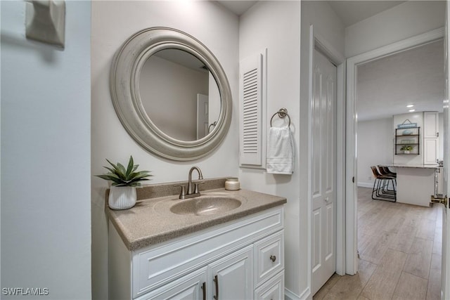 bathroom with vanity and wood-type flooring