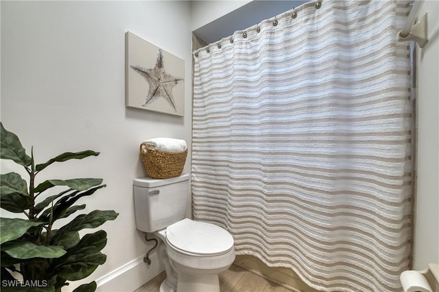 bathroom featuring walk in shower and toilet