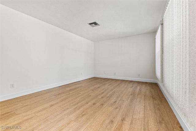 unfurnished room featuring light wood-type flooring