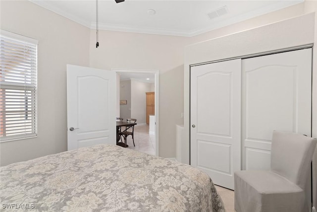 tiled bedroom with a closet and ornamental molding