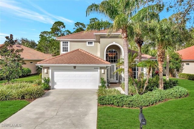 mediterranean / spanish-style house featuring a front lawn and a garage