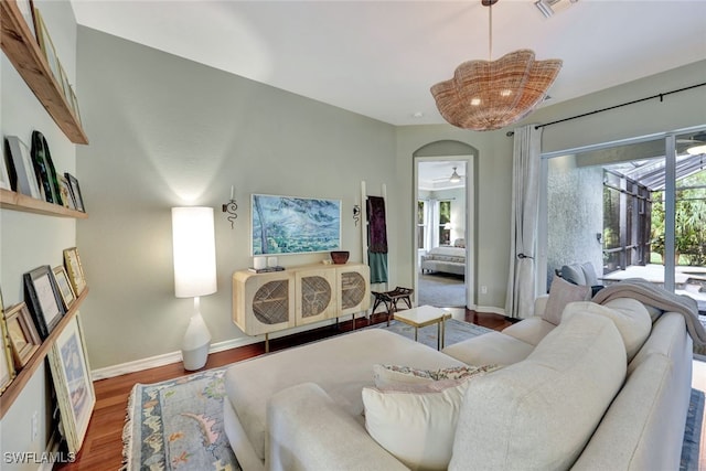 living room with wood-type flooring and ceiling fan