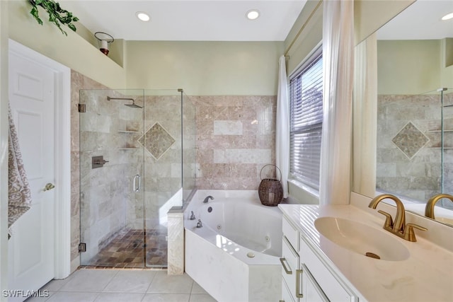 bathroom featuring tile patterned flooring, shower with separate bathtub, and vanity