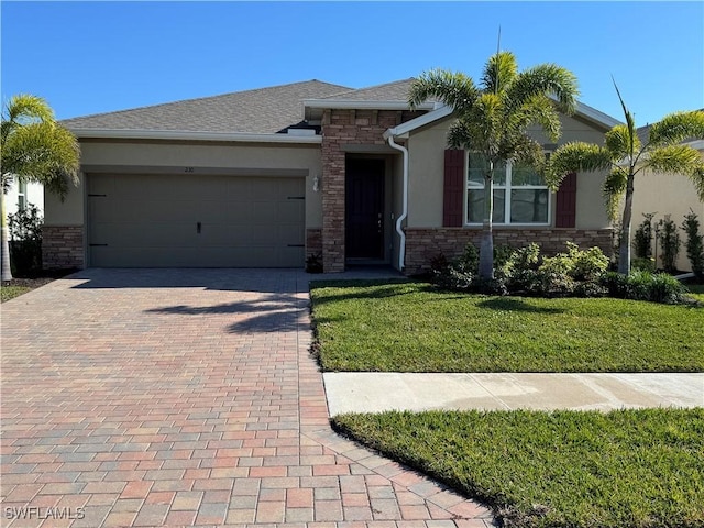 view of front of home with a front lawn and a garage