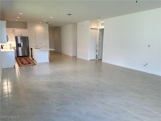 interior space featuring sink and light tile patterned flooring