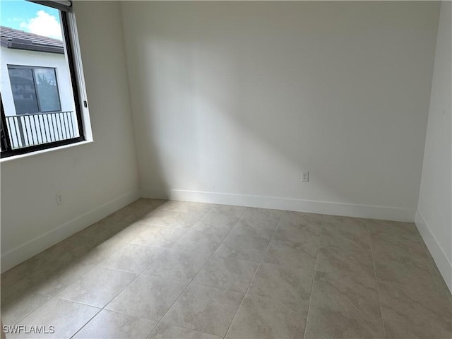 unfurnished room with light tile patterned floors and a healthy amount of sunlight