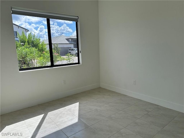 unfurnished room with light tile patterned floors