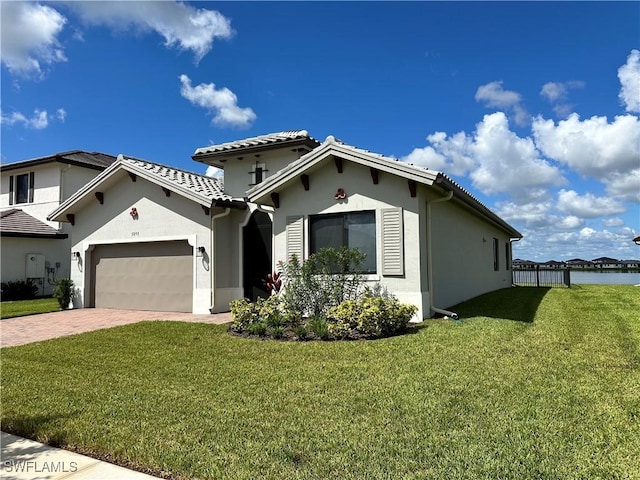 view of front of house with a front yard and a garage