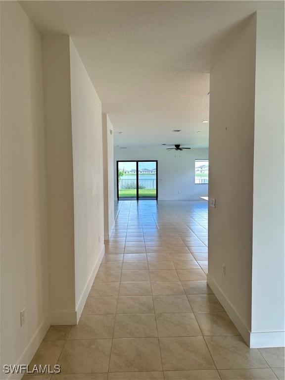 corridor featuring light tile patterned floors