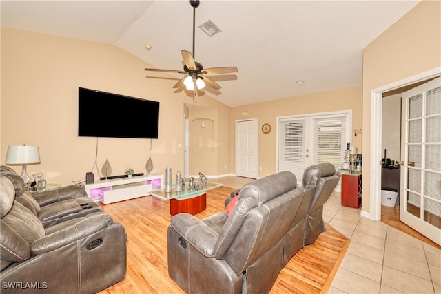 tiled living room featuring ceiling fan and lofted ceiling